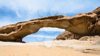 Travel to Middle East country Kingdom of Jordan - bridge sandstone rock in Wadi Rum desert in sunny winter day