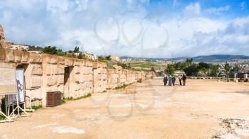 JERASH, JORDAN - FEBRUARY 18, 2012: tourists near wall of circus hippodrome in Gerasa. Greco-Roman town Gerasa (Antioch on the Golden River) was founded by Alexander the Great or his general Perdiccas