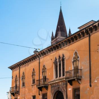 travel to Italy - view of urban house on Via Leoni street and tower of Chiesa di San Fermo Maggiore in Verona city in spring
