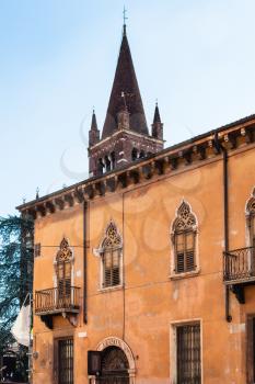 travel to Italy - view of old house on Via Leoni street and tower of Church San Fermo Maggiore in Verona city in spring