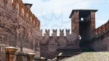 travel to Italy - m-shaped merlons near tower on wall of Castelvecchio (Scaliger) Castel in Verona city in spring