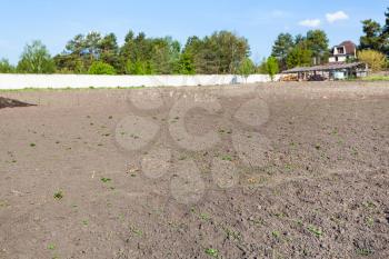 Plowed land on vegetable garden in Ukrainian village in spring