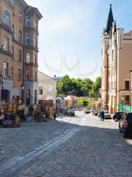 KIEV, UKRAINE - MAY 5, 2017: people and souvenir shops on Andriyivskyy Descent in Kiev city in spring. This street connecting Upper Town district and the historical commercial Podil district