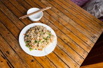 travel to China - top view of fried rice with vegetables on plate in rustic eatery in area Dazhai Longsheng Rice Terraces (Dragon's Backbone terrace, Longji Rice Terraces) country in spring