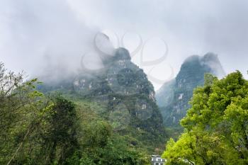 travel to China - clouds over of karst mountains in Yangshuo County in spring season