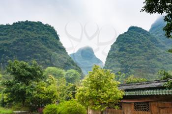 travel to China - gardens in village in karst mountains valley in Yangshuo County in spring season
