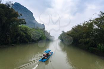 travel to China - chinese ship on river near karst peaks near Xingping town in Yangshuo county in spring