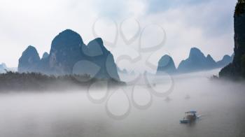 travel to China - panoramic view of fog with boats on river near Xingping town in Yangshuo county in spring morning