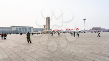 BEIJING, CHINA - MARCH 19, 2017: panorama of Tiananmen Square with visitors, Monument to the People's Heroes and Great hall of The people in spring. Tiananmen Square is central city square in Beijing