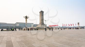 BEIJING, CHINA - MARCH 19, 2017: panorama of Tiananmen Square with tourists, Monument to the People's Heroes and Great hall of The people in spring. Tiananmen Square is central city square in Beijing