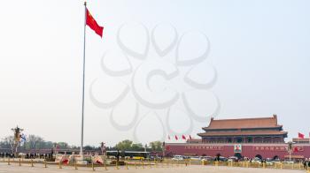 BEIJING, CHINA - MARCH 19, 2017: panorama of Tiananmen Square with guard of honor near the State Flag, tourists and The Tiananmen monument (Gate of Heavenly Peace) on in spring.