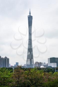 GUANGZHOU, CHINA - MARCH 31, 2017: Guangzhou (Canton) TV Astronomical and Sightseeing Tower over park in spring cloudy day. The tower was topped out in 2009 and it became operational in 2010