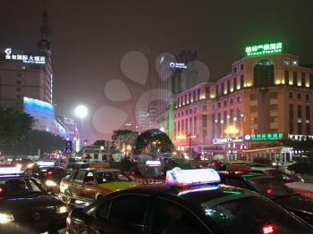 GUILIN, CHINA - MARCH 21, 2017: night traffic on street of Guilin city in spring. The city is in the northeast of China's Guangxi Zhuang Region, there are about 4,8 mln inhabitants