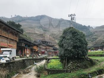 DAZHAI, CHINA - MARCH 23, 2017: street and houses in Dazhai Longsheng village in spring. This is central village in famous scenic area of Longji Rice Terraces in China