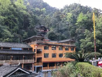 JIANGDI, CHINA - MARCH 26, 2017: bridge and resort hotel in green hills in Guilin Longsheng Hot Springs National Forest Park of Xiangshan District in spring season