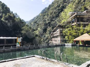 JIANGDI, CHINA - MARCH 26, 2017: outdoor pool with warm water from hot spring in spa hotel in Jiangdi village in resort area Longsheng Hot Springs National Forest Park of Xiangshan District