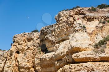 Travel to Algarve Portugal - eroded sandstone rock on beach Praia Maria Luisa near Albufeira city in sunny day