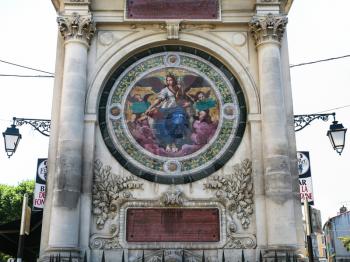 Travel to Provence, France - tile medallion allegory of poetry on Pierre-Amedee Pichot fountain in Arles city