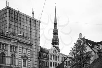travel to Latvia - apartment houses and tower of St Peter's Church in Riga city in autumn