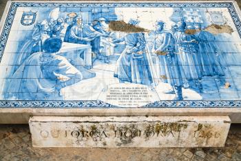 FARO, PORTUGAL - JUNE 25, 2006: Azulejo tile plate with historic snene on public square in Faro city. Faro is capital of the district of the same name, in the Algarve region of southern Portugal