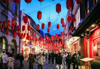 LONDON, UK - JANUARY 20, 2009: visitors in China Town decorated by Chinese lanterns during Chinese New Year in London. First organized Chinese New Year celebrations in the Chinatown took place in 1985