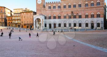 SIENA, ITALY - JANUARY 11, 2009: people Piazza del Campo (Campo square) in Siena city in winter. The historic centre of Siena town has been declared by UNESCO a World Heritage Site