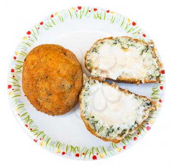 traditional sicilian street food - top view of spinach and sauce stuffed rice balls arancini on plate isolated on white background