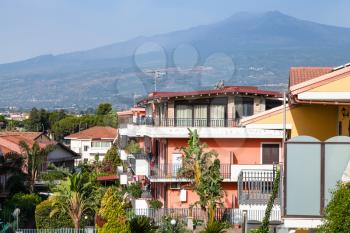 travel to Sicily, Italy - houses on street via Ischia in Giardini Naxos city and view of Etna Mount in summer