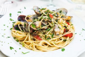 typical italian food - spagetti with vongole on plate in sicilian restaurant