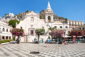 TAORMINA, ITALY - JUNE 29, 2017: tourists on square Piazza 9 Aprile near church Chiesa di San Giuseppe in Taormina city. Taormina is resort town on Ionian Sea in Sicily