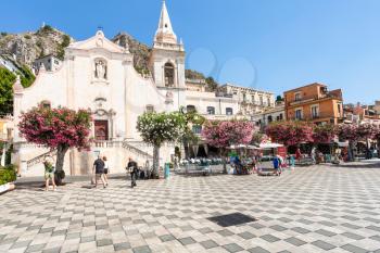 TAORMINA, ITALY - JUNE 29, 2017: people on square Piazza 9 Aprile near church Chiesa di San Giuseppe in Taormina city. Taormina is resort town on Ionian Sea in Sicily