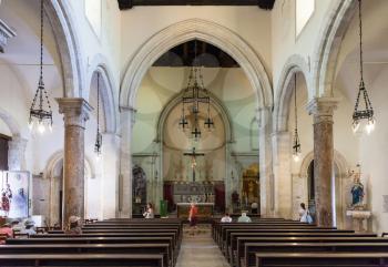 TAORMINA, ITALY - JUNE 29, 2017: visitors inside of Duomo di Taormina (Cathedral San Nicolo di Bari). The cathedral is dedicated to St Nicholas of Bari and San Pancrazio of Taormina.