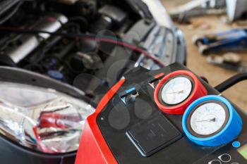 refueling of car air conditioner in auto repair shop
