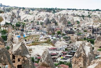 Travel to Turkey - above view of Goreme town with modern and ancient houses in Cappadocia in spring