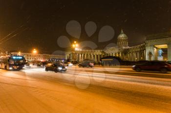 view of snow-covered Nevsky Prospect with Kazan Cathedral in night snowfall in Saint Petersburg city in March