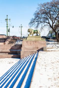 bronze statue of Guard lion near Palace Bridge on Admiralty Embankment in Saint Petersburg city in march