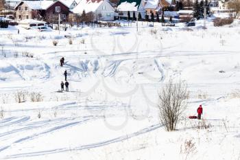 people walk on frozen river in Suzdal town in winter in Vladimir oblast of Russia