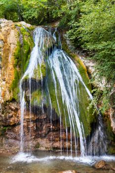 travel to Crimea - Djur-djur waterfall on Ulu-Uzen river in Haphal Gorge of Habhal Hydrological Reserve natural park in Crimean Mountains in autumn. It is the most full-flowing waterfall in Crimea