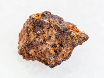 macro shooting of natural mineral rock specimen - raw Hematite (iron ore) stone on white marble background