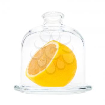 side view of half of yellow lemon in Glass Lemon Keeper isolated on white background