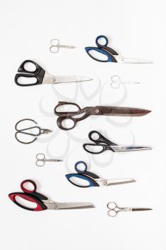 vertical pattern from various scissors on white background