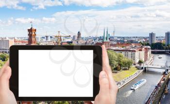 travel concept - tourist photographs Spree River with Rathausbrucke in Berlin city in Germany in september on tablet with cut out screen for advertising logo