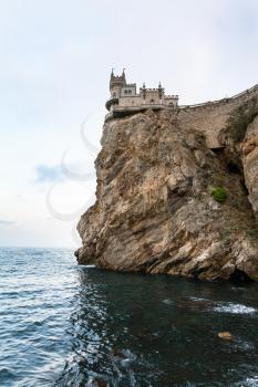 travel to Crimea - view of Swallow's Nest Castle on Aurora Cliff of Ay Todor cape over Black Sea in evening