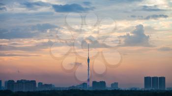 blue and pink dawning over Moscow city with Ostankino TV Tower and Timiryazevskiy park in summer morning