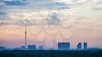 blue and pink daybreak over Moscow city with Ostankino TV Tower and Timiryazevskiy park in summer morning