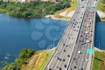 Above view car traffic on bridge over Moskva River on Novorizhskoye Shosse of Russian route M9 Baltic Highway in sunny summer day