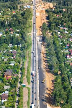 above view of construction of federal highway A107, the Moscow Small Ring Betonka in Istrinsky district of Moscow Region in summer day
