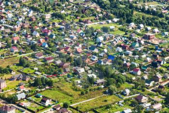 above view of many cottages in suburb village in Moscow Region near Ivanovskoye settlement in Istrinsky district in summer day