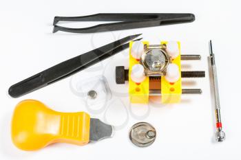 watchmaker workshop - set of various tools for replacing battery in watch on white background