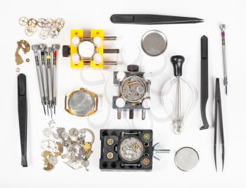 watchmaker workshop - above view of watch repairing tools on white background